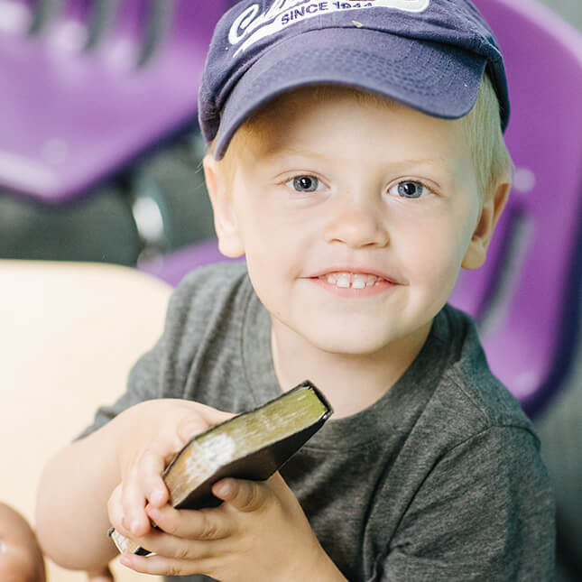 child holding bible